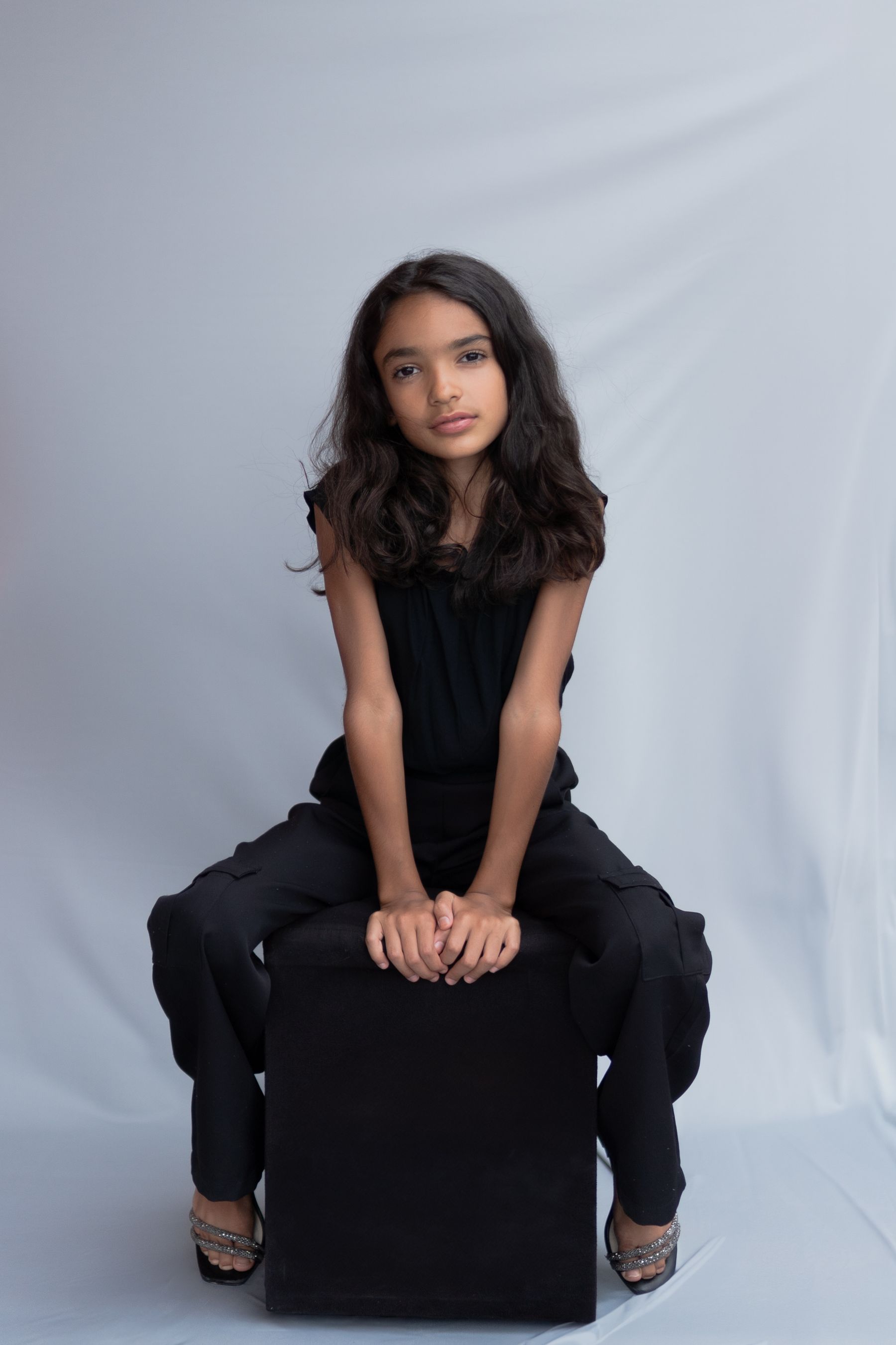 Young model in a sleek black jumpsuit