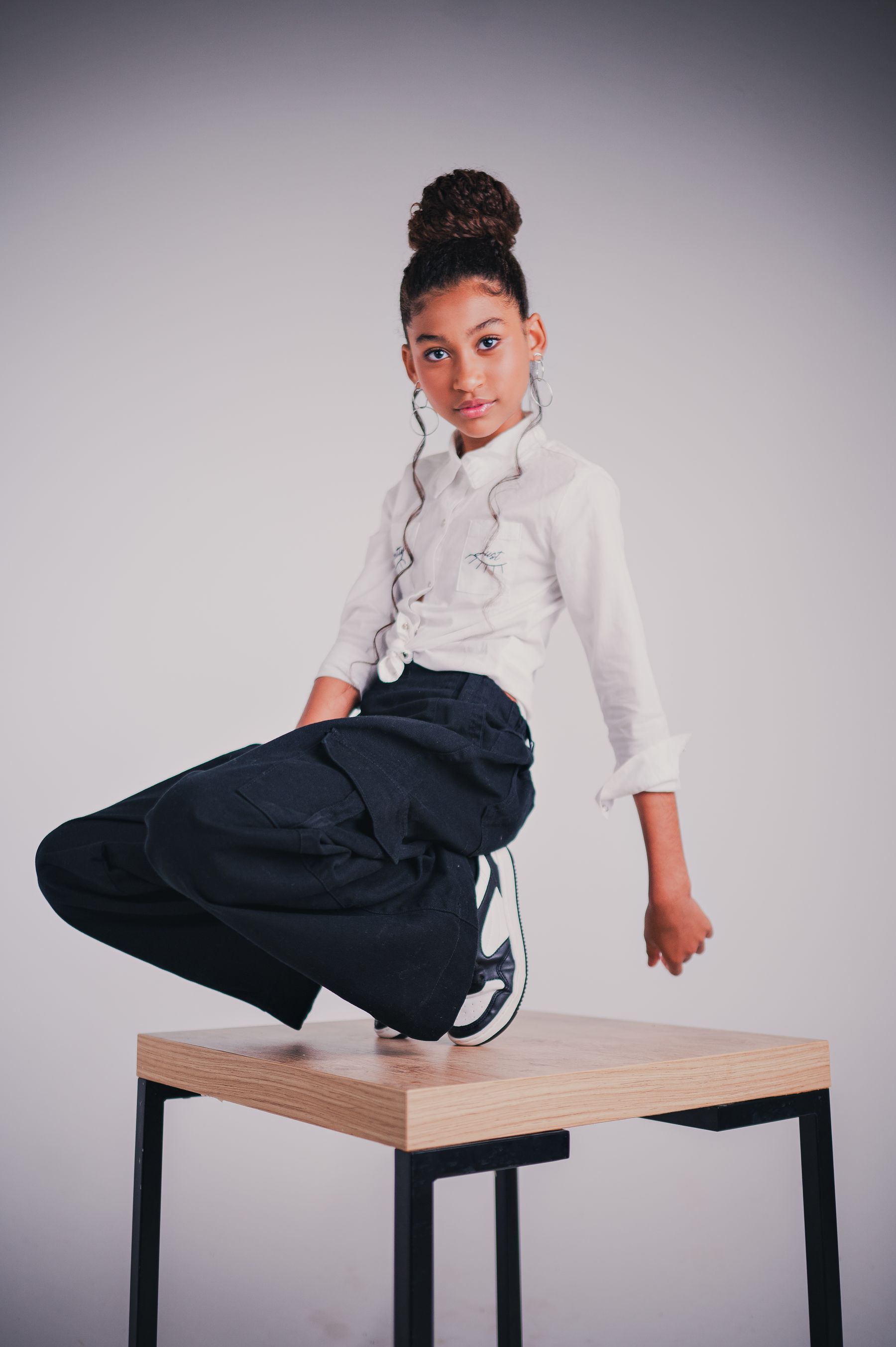 Young model posing in an editorial studio setup