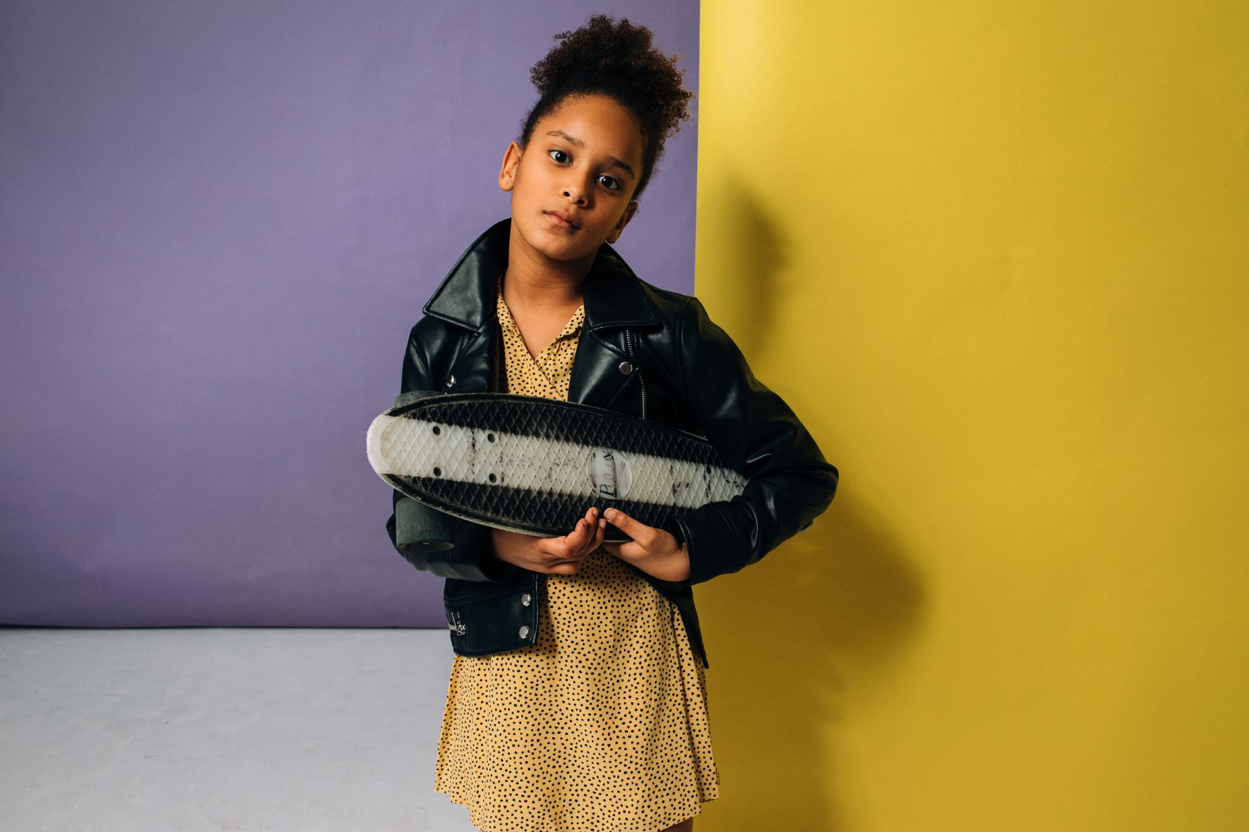 Young model posing against a bold colored wall